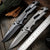 High Hardness Steel Folding Survival Pocket Knife displayed on a wooden table with a ruler and natural elements.
