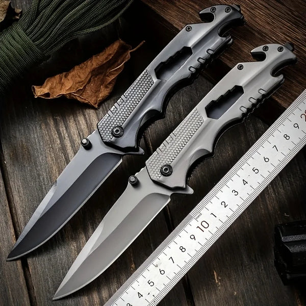 High Hardness Steel Folding Survival Pocket Knife displayed on a wooden table with a ruler and natural elements.
