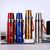 Four 600ml Stainless Steel Thermos Bottles in red, blue, gold, and silver displayed on a table.
