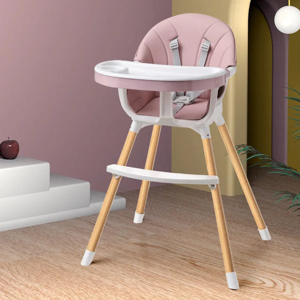 Portable Baby Booster Seat Harness with soft seating and wooden legs in a modern home setting.