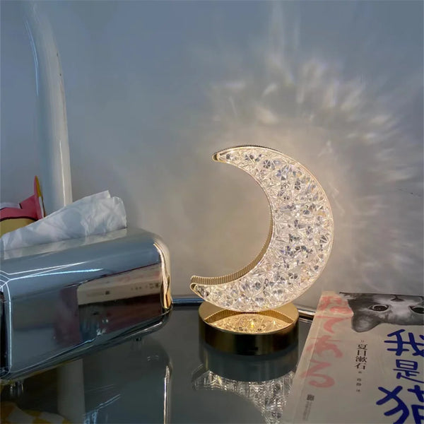 Luxury Crystal Star and Moon Rechargeable LED Table Lamp illuminated on a bedside table, creating a cozy atmosphere.