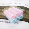 Plastic Hair Curlers Rollers 6pcs in pink and blue resting on a wooden plate with a decorative background.