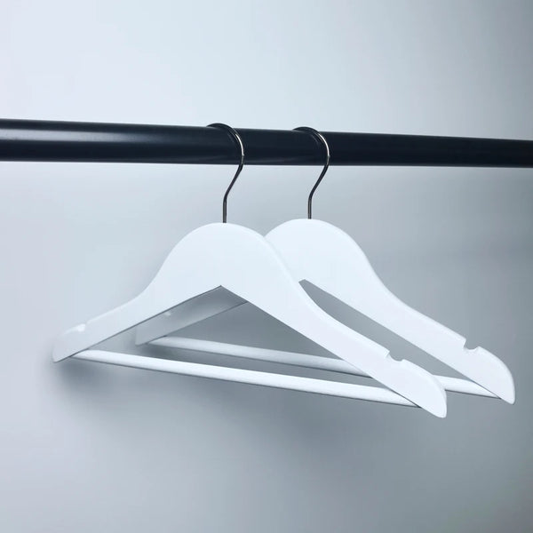 Boutique Wooden Kids Clothing Hanger displayed on a black rod, showcasing its sleek and stylish design for children's garments.