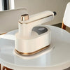 Portable Handheld Garment Steamer on a table, designed for wrinkle-free clothing on the go.