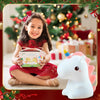 Happy girl in red dress with Kids Gifts LED Touch Sensor Baby Night Light unicorn design and gift box in festive setting.
