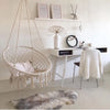 Portable Heavy Duty Outdoor Rope Hammock in a bright, cozy indoor space with modern decor and a macrame chair.