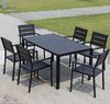 Outdoor Teak and Aluminium Dining Table with 4 Armchairs set in a garden, showcasing durable outdoor furniture.