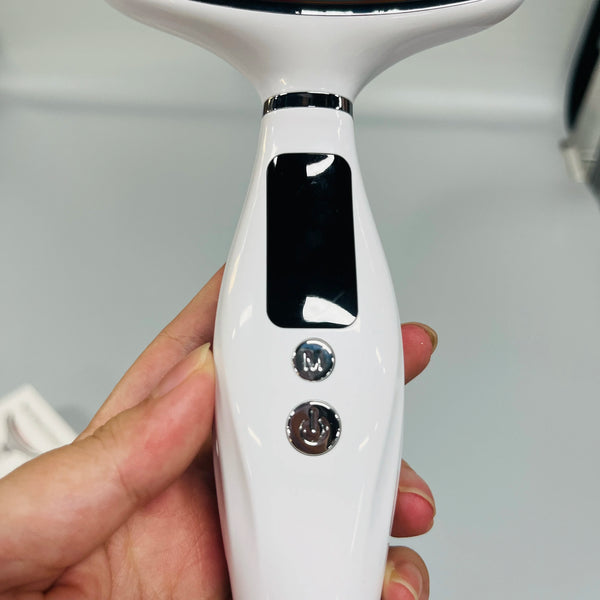 Close-up of the control panel of the 7 in 1 Facial and Neck Massager showing buttons and screen.