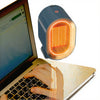 Portable PTC Electric Fan Heater providing instant warmth next to a laptop during chilly mornings.