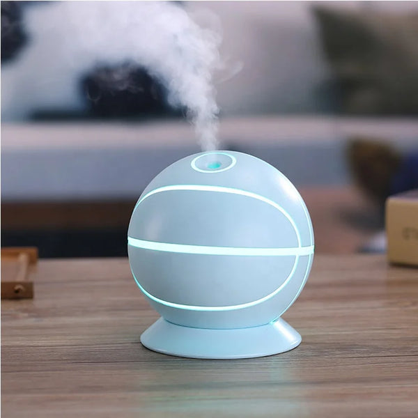 Basketball Mini USB Humidifier Lamp emitting mist with soft ambient light on a wooden table.