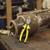 8-Inch Steel Cutting Pliers on a workbench showcasing its heavy-duty design for industrial use.