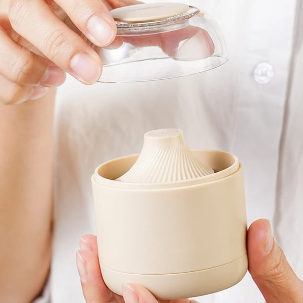 Person holding an Electric Fabric Lint Remover with transparent lid, showcasing its design and functionality in cleaning fabric surfaces.