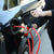 User operating a Manual Siphon Pump and Fluid Transfer System to drain fuel from a vehicle.