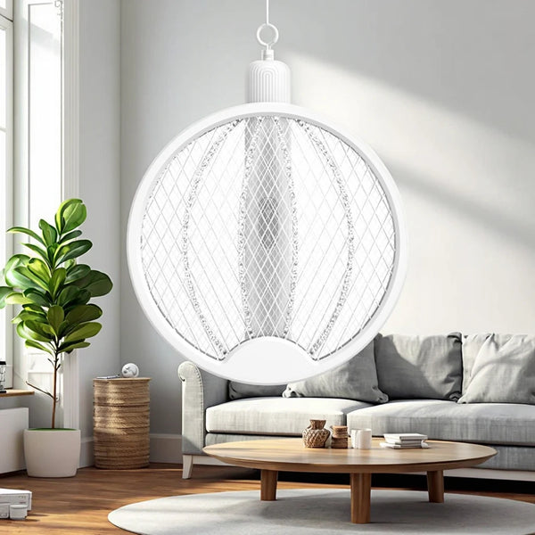 Rechargeable Electric Mosquito Swatter hanging in a bright living room with a cozy sofa and plants.