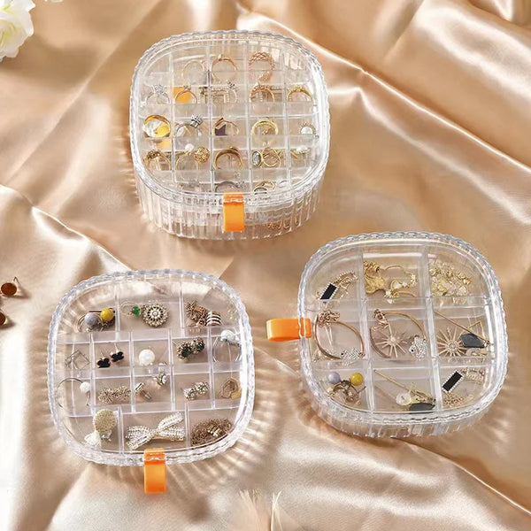 Portable Multi-Layer Plastic Jewelry Storage Box in three sections displaying organized earrings and rings.
