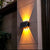 Solar LED RGB Wall Light installed on a wall, illuminating outdoor space with warm light.