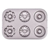 Non-Stick 6-Cavity Mini Fluted Tube Pan showing six distinct fluted designs for baking elegant desserts.