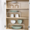 Single Layer Kitchen Metal Shelf Organizer displaying stacked plates and jars in a wooden cabinet.