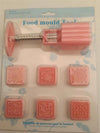 Hand Press Mooncake & Pastry Mold Set showcasing a pink food mold tool with detailed pattern stamps for baking.