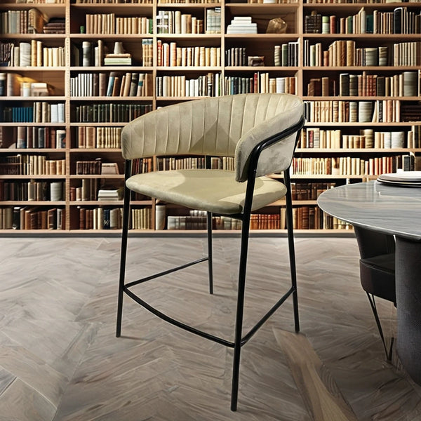 Upholstered Bar Stool with Curved Back and Black Metal Frame in a stylish interior with bookshelves.