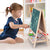Young girl drawing on a Wooden Double-Sided Drawing Blackboard & Whiteboard, promoting creativity and learning.