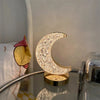 Luxury Crystal Star and Moon Rechargeable LED Table Lamp illuminating a cozy bedside table with a moon design.