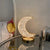 Luxury Crystal Star and Moon Rechargeable LED Table Lamp illuminating a cozy bedside table with a moon design.