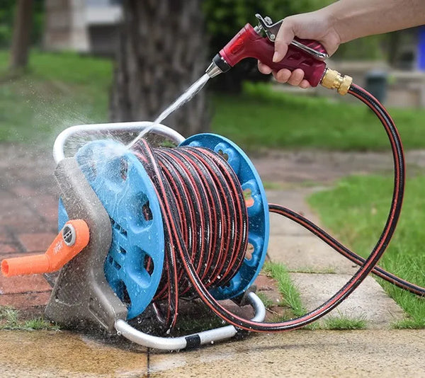 Durable Garden Irrigation Hose Reel with Hose being used to spray water in a garden setting.