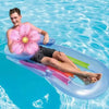 King Kool Lounges Inflatable Chairs with a man relaxing on a colorful pool float in clear water.