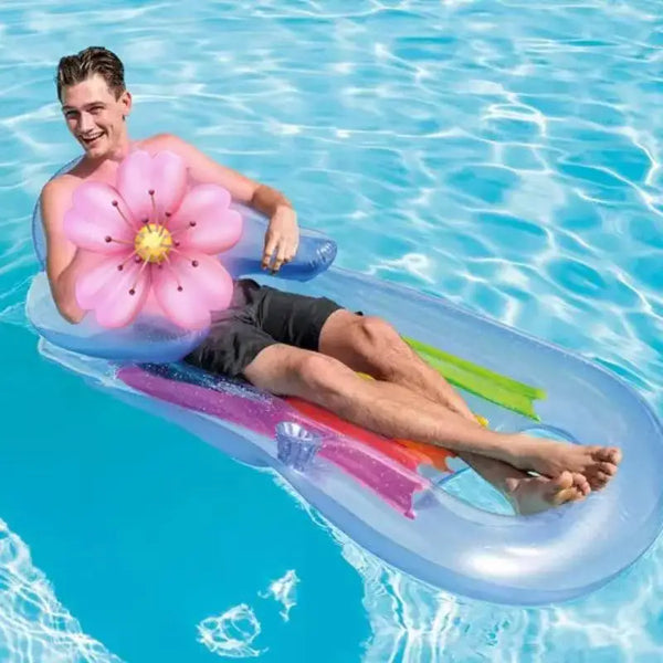 King Kool Lounges Inflatable Chairs with a man relaxing on a colorful pool float in clear water.