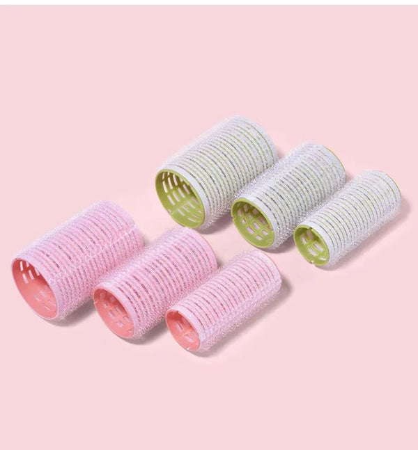 Self-Adhesive Air Fringe Hair Rollers in pink and green colors on a pink background.