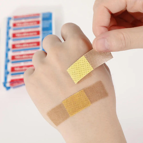 Person applying Breathable PE Adhesive Wound Plaster on a hand, showcasing its breathable design for injury protection.