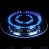 Close-up of a blue flame on the 5 Burner Glass Gas Cooker Cooktop Induction Stove, showcasing its efficient heating.