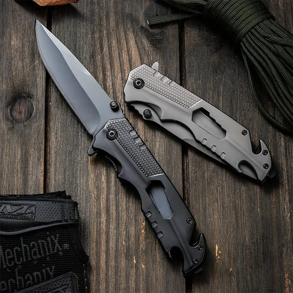 High Hardness Steel Folding Survival Pocket Knife resting on a wooden surface, showcasing its sleek design and dual-tone finish.