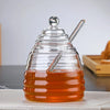 Hand-Blown Bee-Shaped Borosilicate Glass Honey Jar with a sleek design and a convenient honey dipper.