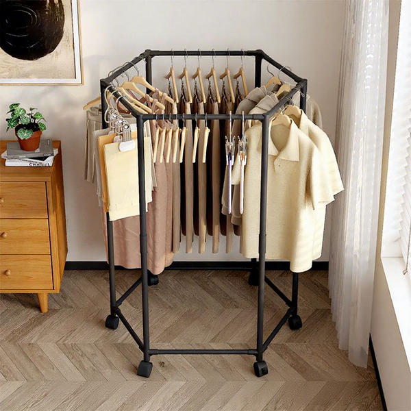 Rotating Clothes Rack with Wheels displaying multiple clothing items in a stylish interior setting.