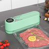 Handheld Vacuum Sealer for Food sealing meat with a digital display in a modern kitchen setting.
