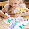 Child using the Magic Light Drawing Pen Set with LED Glow Board to create colorful designs on special paper.