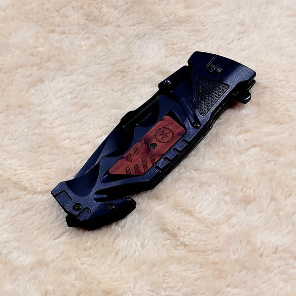 Non-Slip Stainless Steel Folding Meat Knife resting on a soft surface, showcasing its compact and ergonomic design.