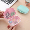 Weekly Pill Organizer Case opened with colorful pills, ideal for medication management at home and travel.