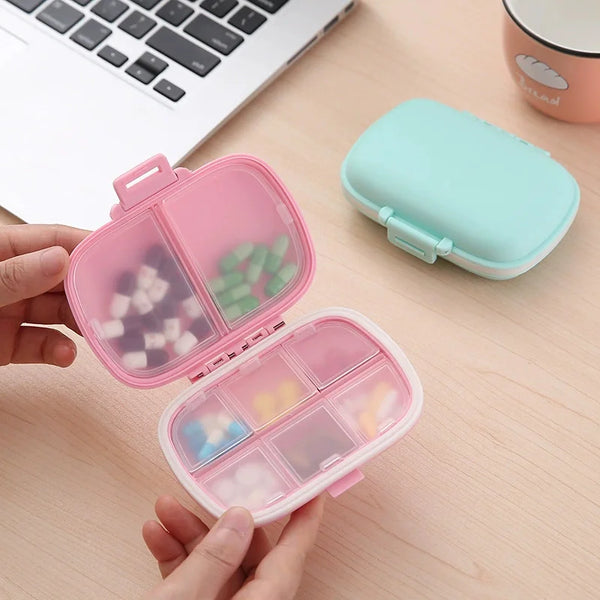 Weekly Pill Organizer Case opened with colorful pills, ideal for medication management at home and travel.