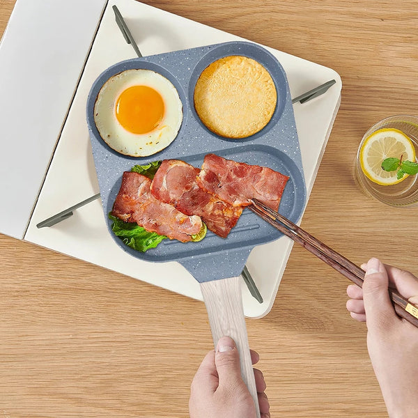 3 Hole Non Stick Die Cast Frying Pan with eggs, pancakes, and bacon, featuring non-stick compartments.