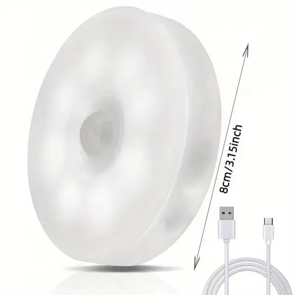 Rechargeable Motion Sensor LED Night Light features a round design with a USB-C charging cable for easy use.