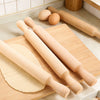 Wooden Rolling Pin on a kitchen countertop with eggs and rolled dough for baking.