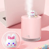 6.5-Inch USB Rabbit Humidifier with Light in pink on a desk, emitting steam and featuring a cute rabbit design.