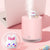 6.5-Inch USB Rabbit Humidifier with Light in pink on a desk, emitting steam and featuring a cute rabbit design.