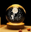 Crystal Milky Way LED Globe 6 cm featuring 3D engraving with a moon and stars on a wooden base.