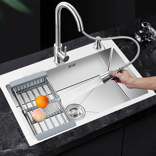 Single Bowl Stainless Steel Kitchen Sink with fruits being washed under spray faucet.