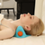 A woman relaxing with the EMS Heat Vibrating Back and Neck Massage Pillow for soothing neck relief.