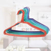 Colorful PVC Coated Metal Clothes Hangers 10 Pack displayed in a modern living room setting.